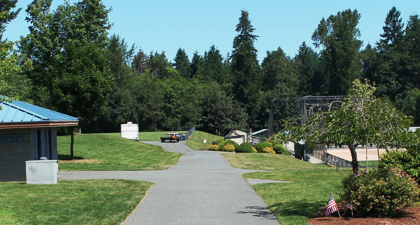flat paved pathway at east sammamish park, leading to restrooms and a ballfield