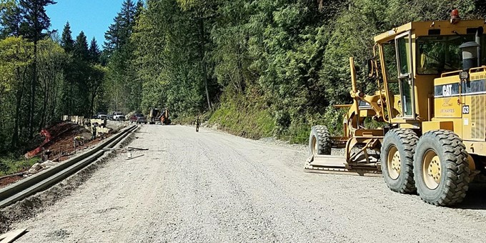 Heavy equipment evens out the dirt and gravel on 212th Way Southeast before paving it as part of the work of the 212th Way (Snake Hill) Road Slide Repair.