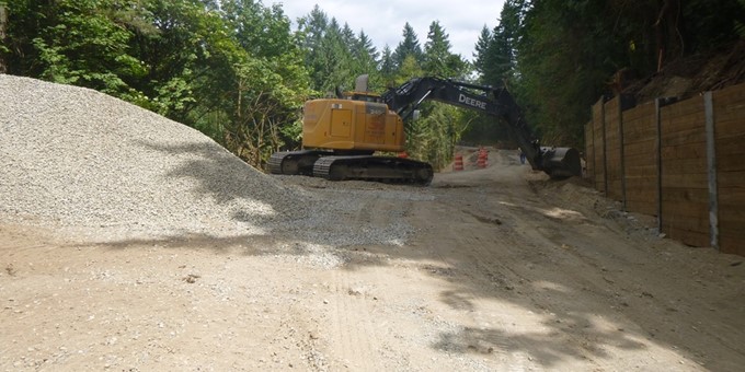 Excavator at work at a new retaining wall as part of the work on 212th Way Southeast as part of the 212th Way (Snake Hill) Road Slide Repair work.
