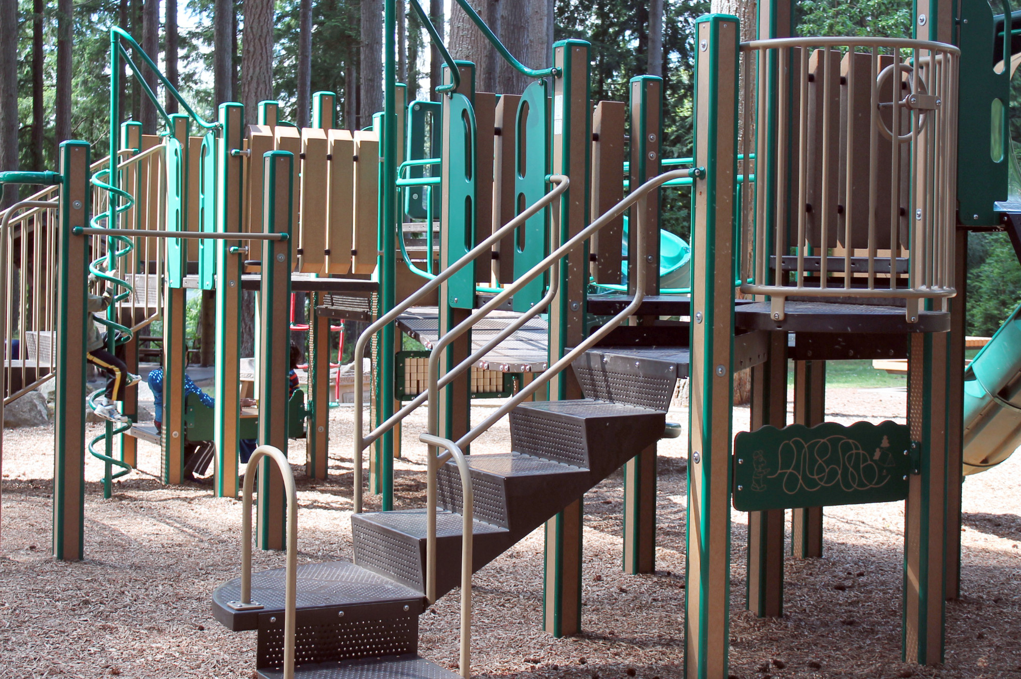 Pine Lake Park playground structure with slides, steps, bars, poles, and other apparatuses. 
