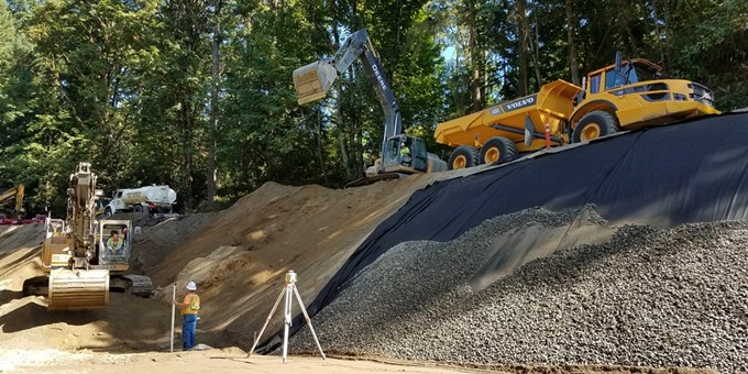 Crew members working with two excavators on rebuilding at retaining wall at 212th Way Southeast as part of the 212th Way (Snake Hill) Road Slide Repair Work.