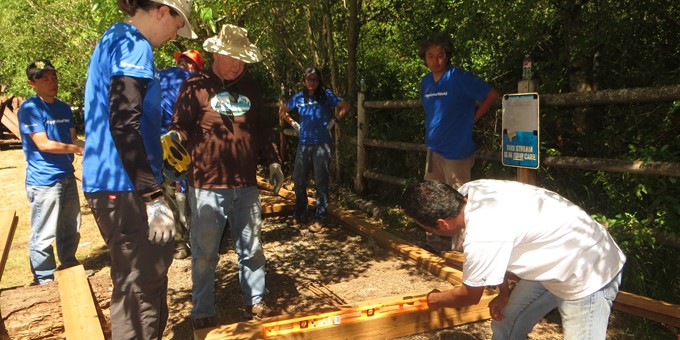 Seven Sammamish stewards collaborating on a boardwalk trail project.