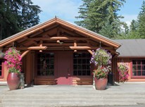 Front entrance to Beaver Lake Lodge with a giant flower-filled pot on each side of entrance. 